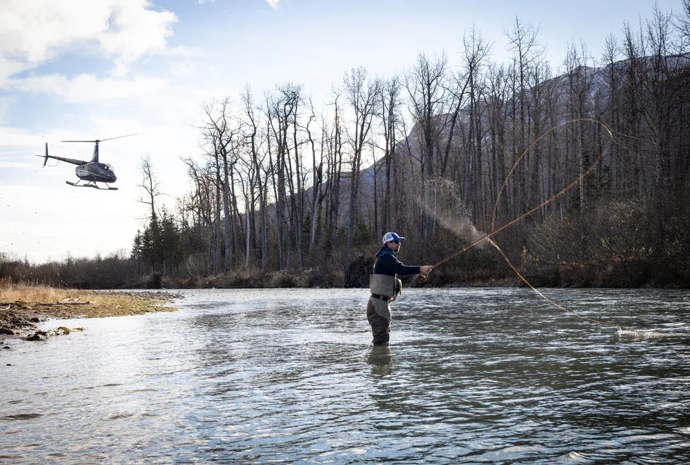 Angler holding a chrome-bright Kenai Peninsula steelhead