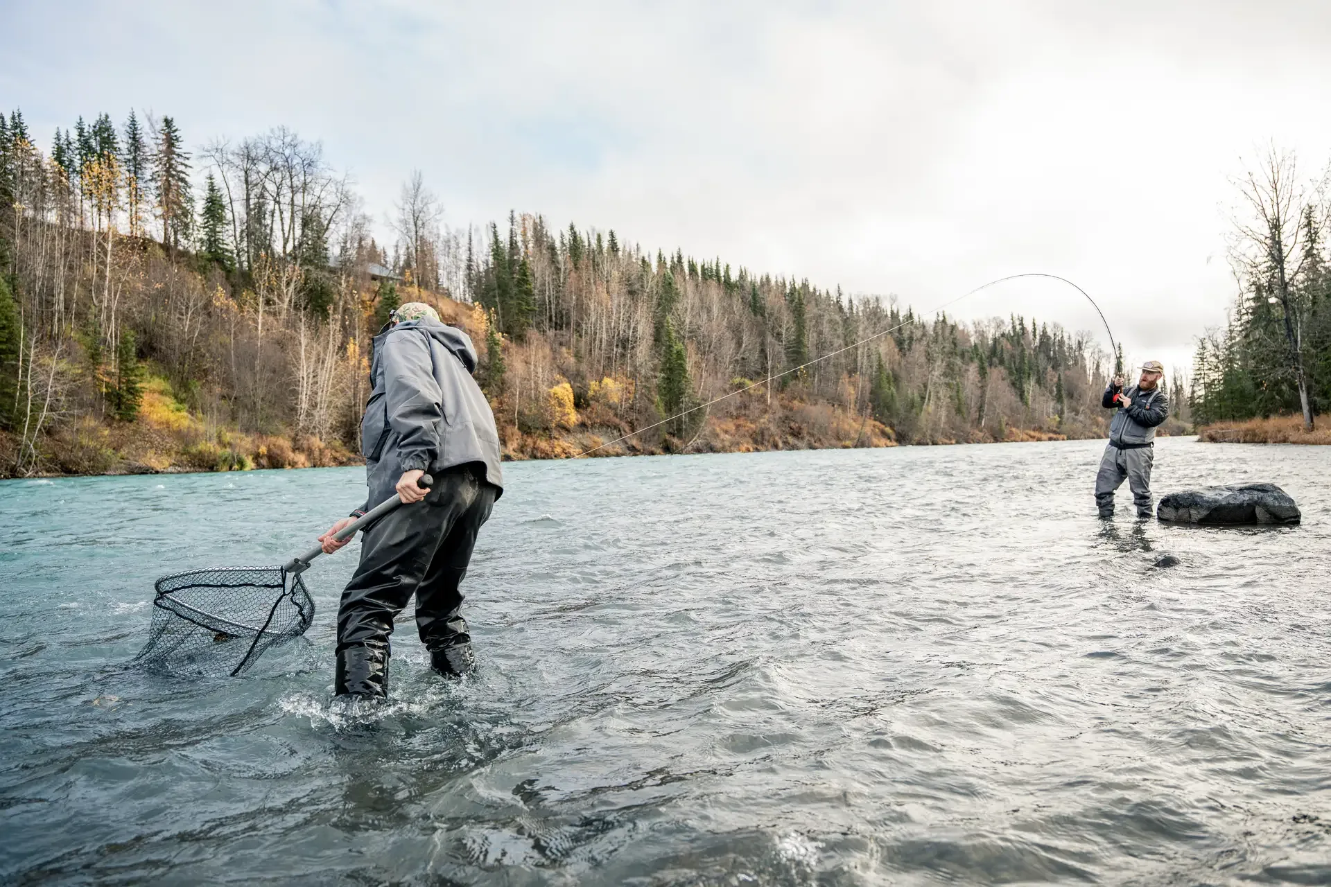 Spey angler swinging a fly across a wide Kenai run